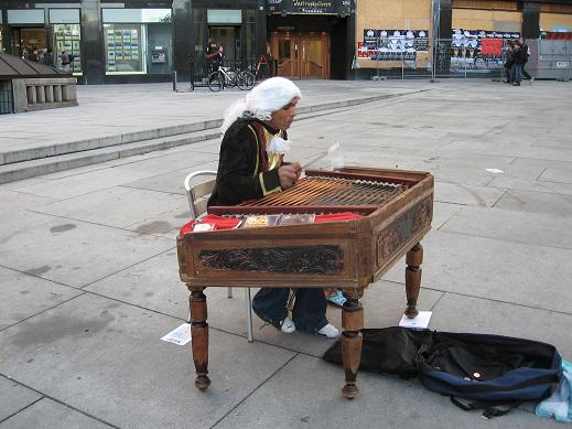 Street musician playing unknown instrument